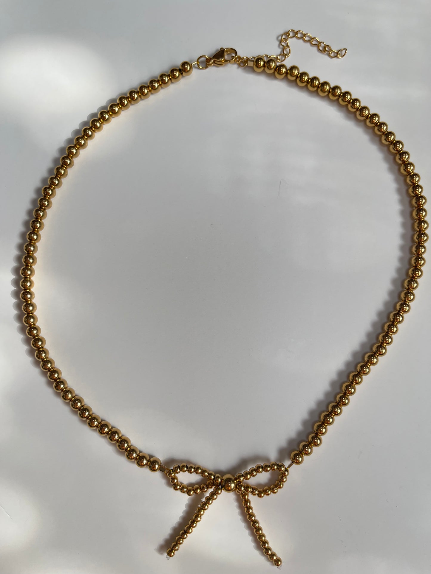 COLLAR DORADO CON MOÑO